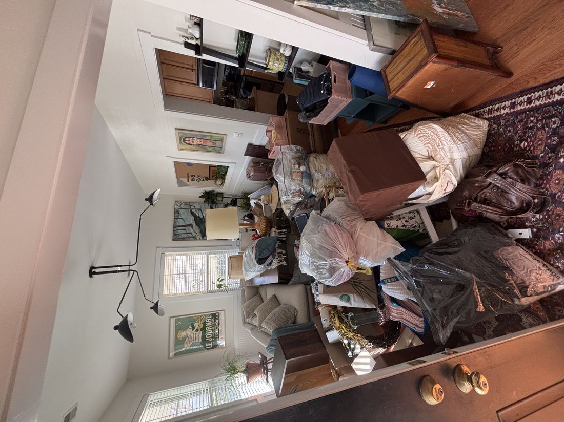 Estate cleanout — living room packed with belongings after someone passes